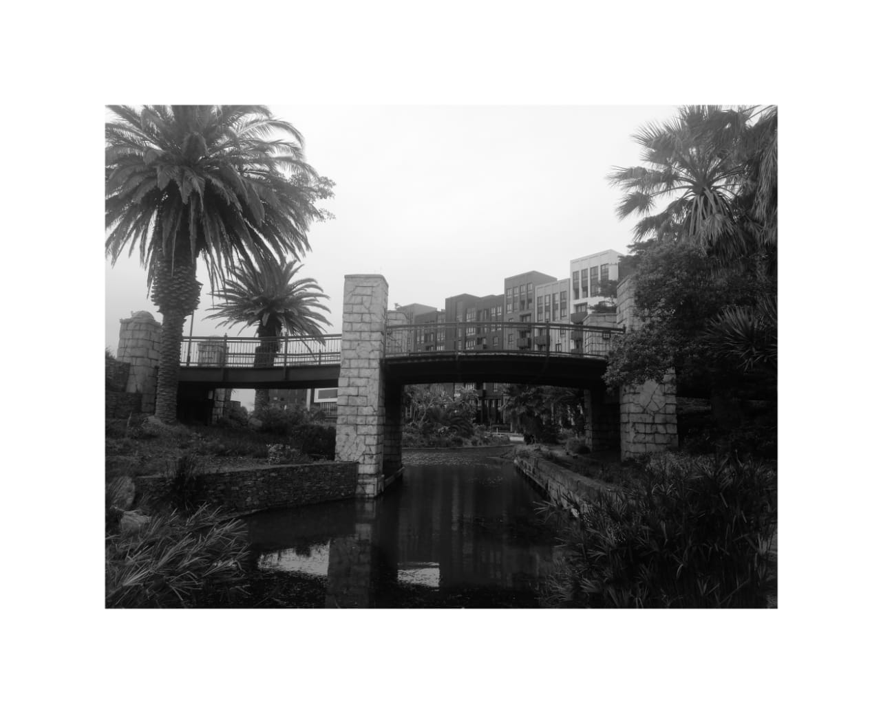 Black and white stone bridge over a canal