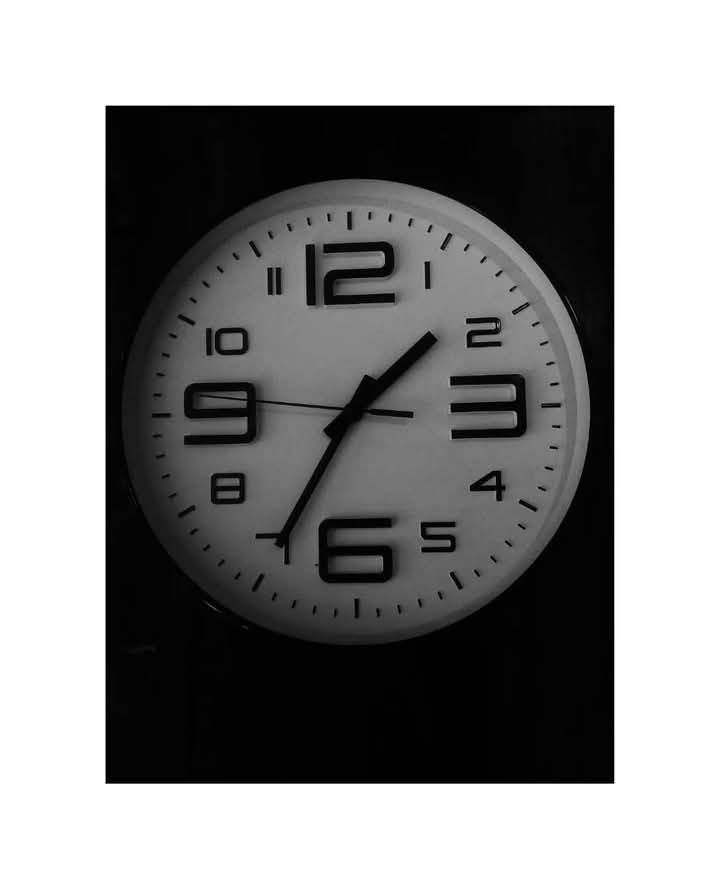 Black and white close-up of a round clock