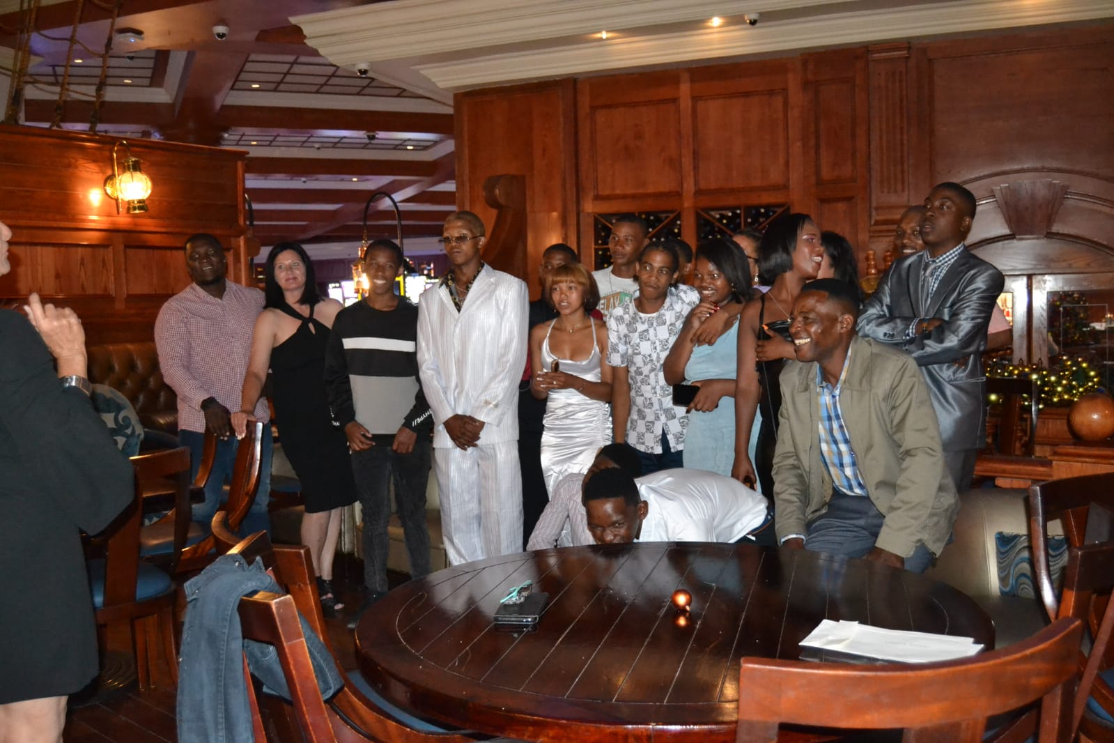 Guests gathered around a table in a wood-panelled restaurant