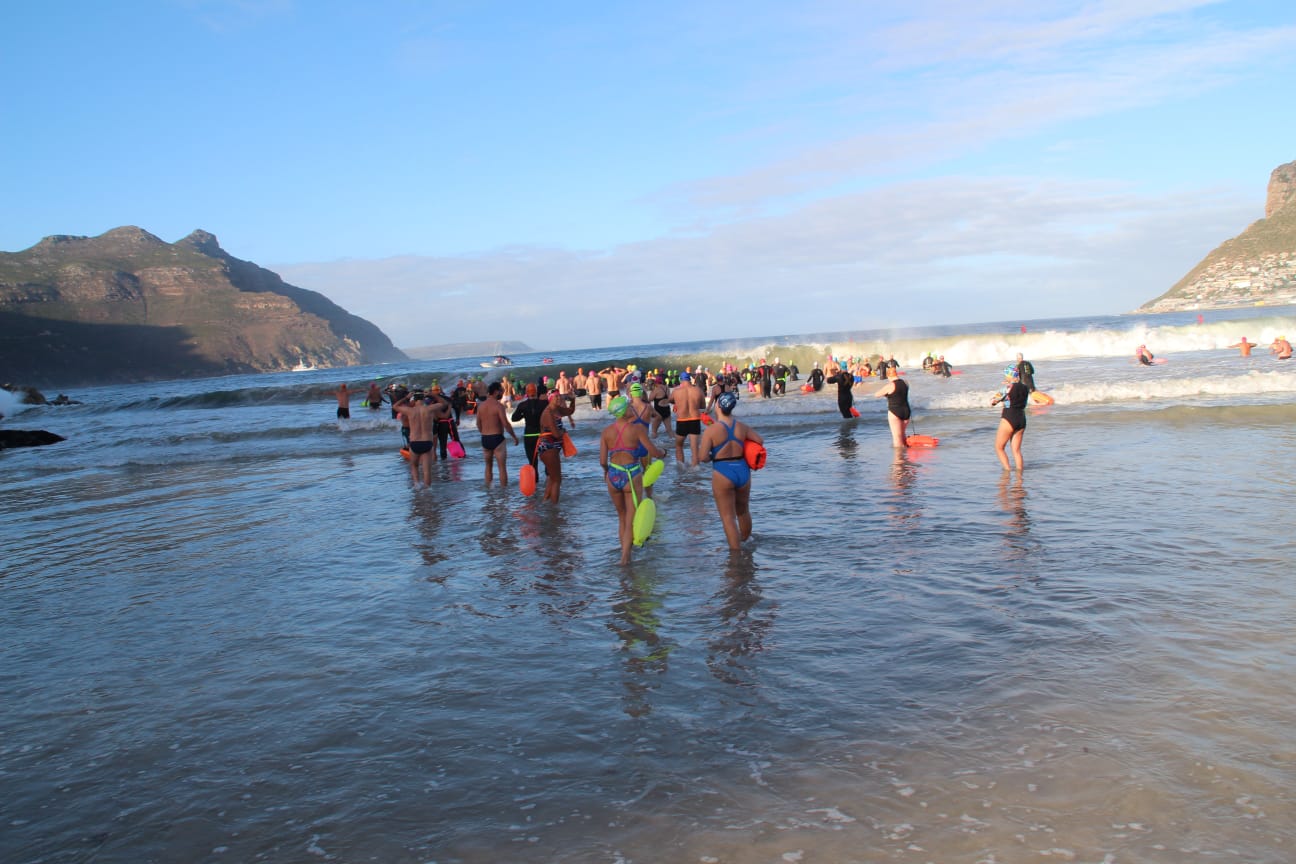 Swimmers wading into the sea