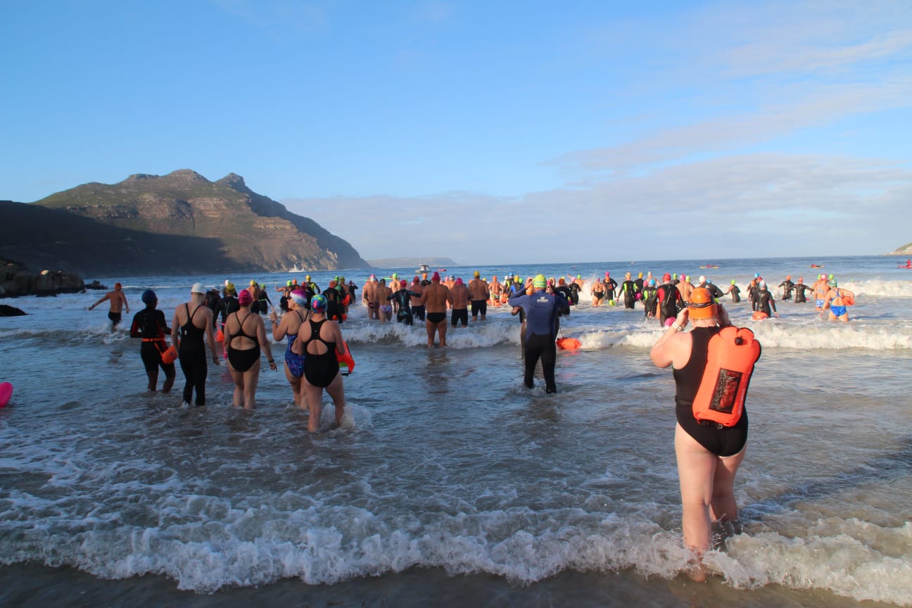 Swimmers walking into the surf