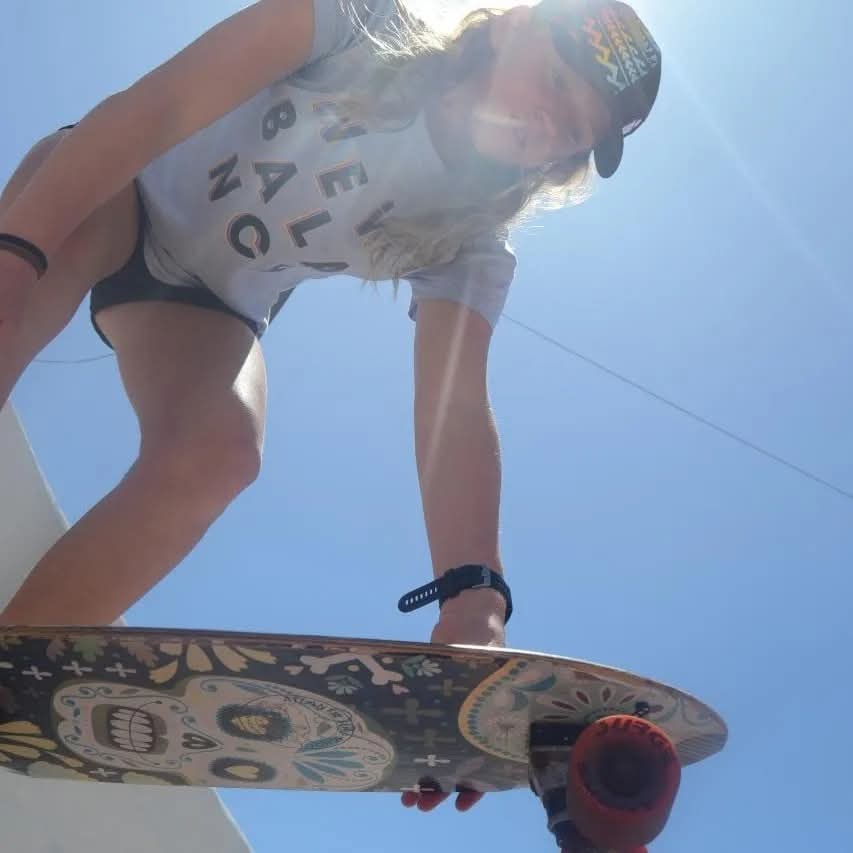 Low angle of a skateboarder holding the board