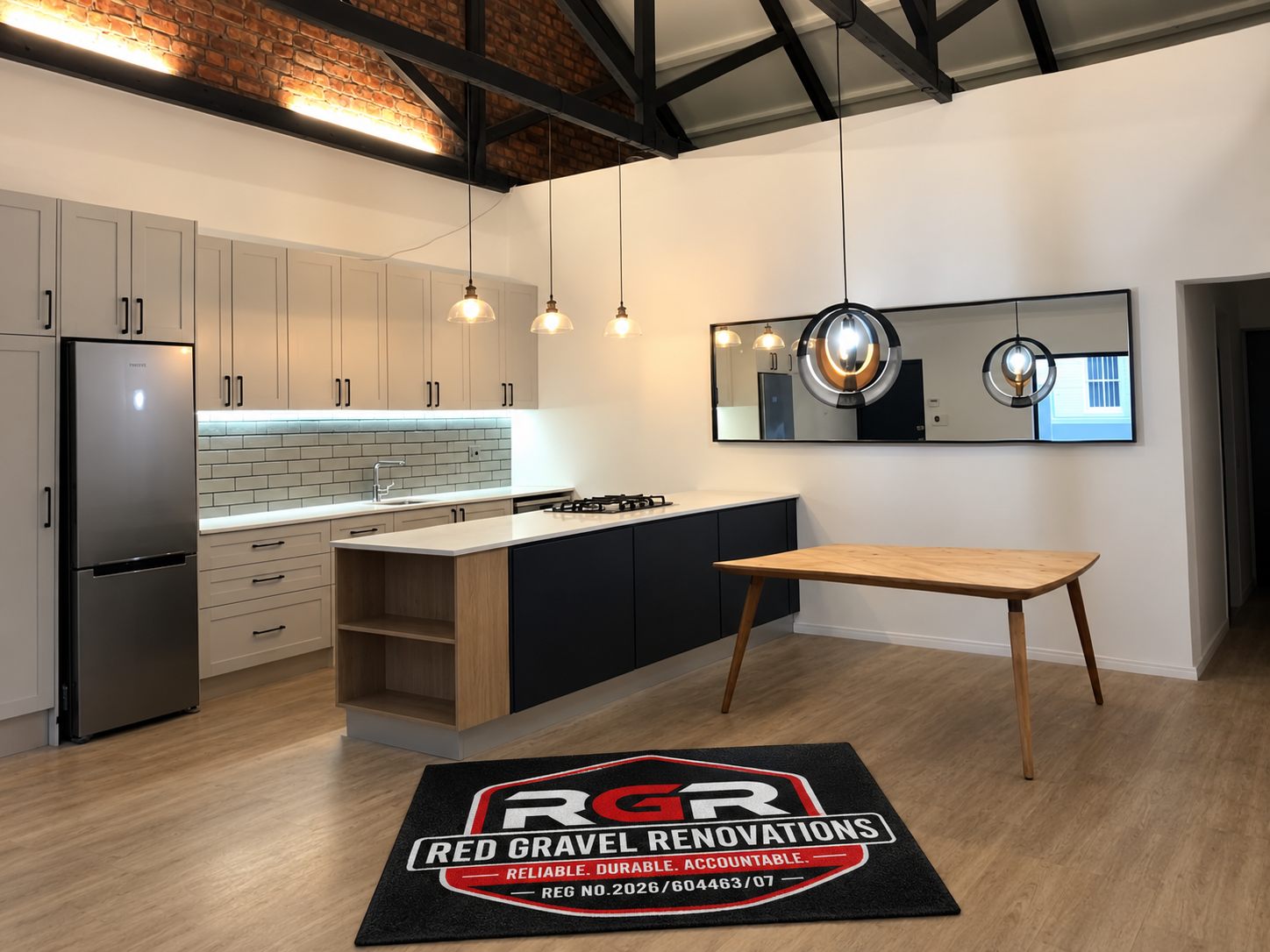 Finished kitchen with pale cabinets and a timber table