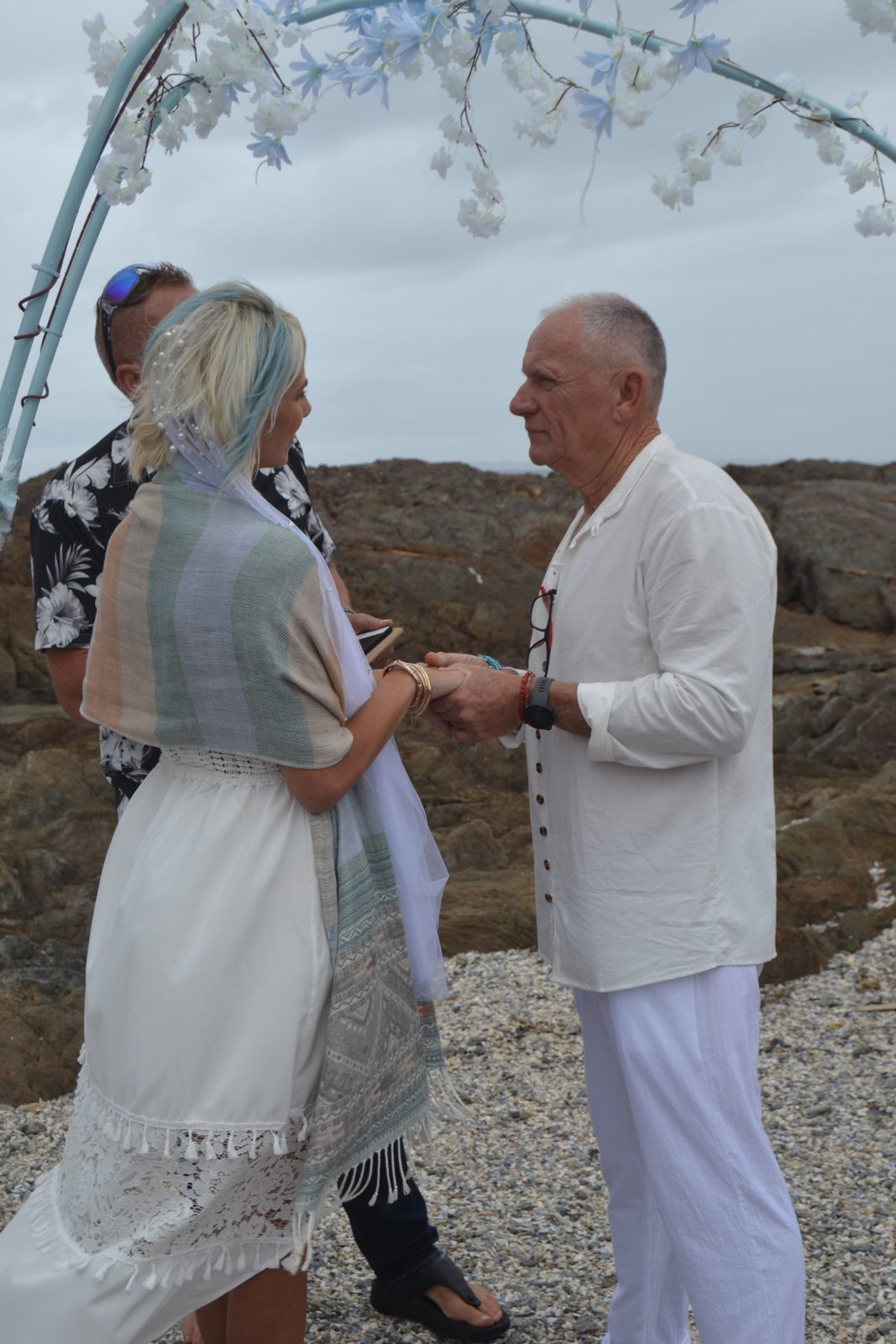 Couple exchanging vows on a pebble beach